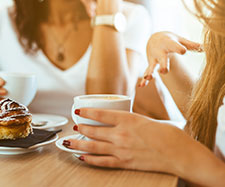 females having a discussion over coffee