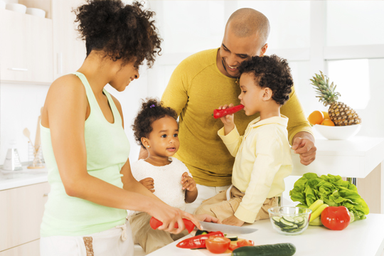Cheerful family preparing food in the kitchen Cheerful family preparing food in the kitchen