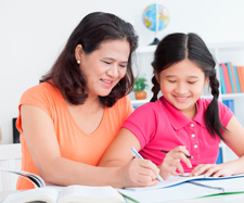 Mother helping her daughter with her home-work Mother helping her daughter with her home-work