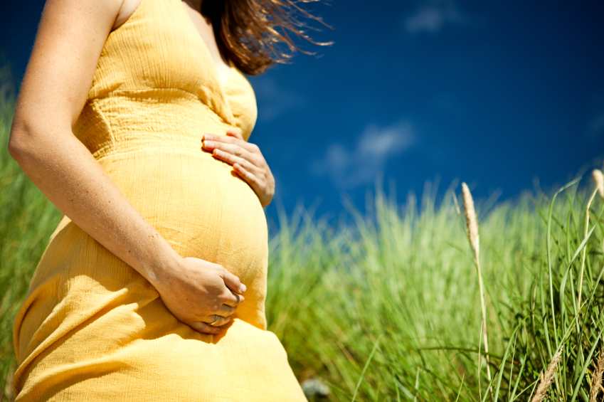 pregnant woman holding belly